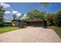 Charming mid-century home with well-maintained lawn and covered parking at 2129 Ridge Rd, Raleigh, NC 27607