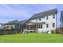 Spacious backyard featuring a screened-in porch, lush green grass, and a playset at 217 Tumbling River Dr, Wendell, NC 27591