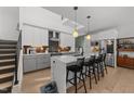 Bright kitchen features a center island with seating, stainless appliances and white and gray cabinetry at 2201 Millbank Village Ct # 101, Raleigh, NC 27610