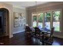 Dining room with large windows, chandelier lighting, and a table with seating for six at 2725 Belmont View Loop, Cary, NC 27519