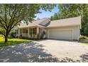 Inviting single-story home featuring a two-car garage and red shutters, plus a front porch at 3000 Hidden Spring Ln, Oxford, NC 27565