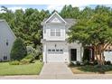 Inviting two-story home featuring lush landscaping, an attached garage, and a freshly painted exterior at 3021 Winding Waters Way, Raleigh, NC 27614