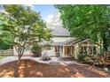 Private backyard featuring a stone patio, perfect for outdoor dining and entertaining, surrounded by mature trees at 3025 Bentwillow Dr, Fuquay Varina, NC 27526
