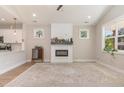 Inviting living room with fireplace, mantel, large rug and multiple windows to let the sunshine in at 303 Godwin St, Selma, NC 27576