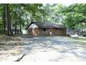 Charming brick single story house surrounded by mature trees at 3204 Friar Tuck Rd Rd, Raleigh, NC 27610