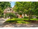 Charming home with a well-maintained lawn and mature trees providing shade and curb appeal at 429 Carolina Cir, Durham, NC 27707