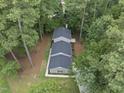 Aerial view of a home showing the roofline and surrounding mature trees at 4301 Azalea Dr, Raleigh, NC 27612