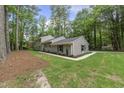 Well-maintained home with a tidy lawn and landscaping in a serene, wooded setting at 4301 Azalea Dr, Raleigh, NC 27612