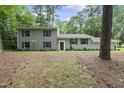 Inviting two-story home with a lush lawn and mature trees offering shade and privacy at 4301 Azalea Dr, Raleigh, NC 27612