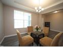 Inviting living room with a large window and comfortable seating arrangement at 4416 Walker Hallow St, Raleigh, NC 27616