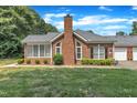 Beautiful brick home with manicured lawn and mature trees at 4622 Ludwell Branch Ct, Raleigh, NC 27612