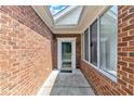 Inviting front porch with brick walls and windows at 4622 Ludwell Branch Ct, Raleigh, NC 27612