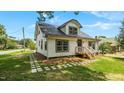 Exterior view of a house with white siding, black trim, metal roof and a stepping stone walkway at 505 Hawfields Rd, Mebane, NC 27302