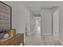 Hallway with light gray walls, modern light-colored flooring, and decorative wall art at 505 Hawfields Rd, Mebane, NC 27302