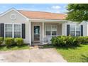 Attractive single-Gathering home with a cozy front porch, well-maintained landscaping, and a welcoming entrance at 5104 Parkerwood Dr, Knightdale, NC 27545