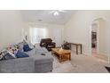 Bright living room with plush seating, neutral colors, and natural light, creating a comfortable living space at 5104 Parkerwood Dr, Knightdale, NC 27545