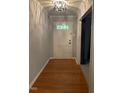 Welcoming entryway featuring hardwood floors, modern lighting, and fresh paint at 512 Crestview Dr, Durham, NC 27712
