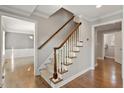Classic staircase with wood railing, carpeted steps, and decorative trim, leading to the upper level of the home at 5509 Cliffwood Ct, Raleigh, NC 27609