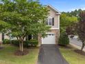 Inviting townhome with a stone facade, attached garage and mature trees at 5515 South Roxboro # 32, Durham, NC 27713