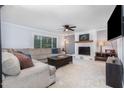 Spacious living room featuring a fireplace, large sectional, and a mounted television at 5900 Holly Dr, Raleigh, NC 27616