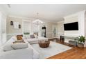 Bright living room with hardwood floors, a comfortable sectional sofa, and stylish decor at 6 Tulip Tree Ct, Durham, NC 27712