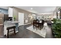Open concept dining area with hardwood floors and seating for six people at 605 Smallwood Dr, Durham, NC 27703