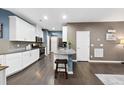 Modern kitchen with white cabinets, stainless steel appliances, and granite countertops at 605 Smallwood Dr, Durham, NC 27703