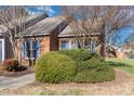 Brick townhome featuring tidy landscaping and a well-kept lawn at 61 Fashion Pl, Durham, NC 27705
