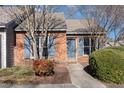 Charming brick townhome with well-maintained landscaping and blue shutters at 61 Fashion Pl, Durham, NC 27705
