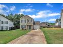 Charming two-story home with a well-manicured lawn, attached garage, and inviting curb appeal at 71 Herndon Ct, Clayton, NC 27520