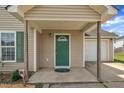 Welcoming front porch with a vibrant green door and a cozy entrance to the home at 71 Herndon Ct, Clayton, NC 27520