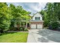 Charming two-story home featuring brick facade, a two-car garage, covered porch, and well-maintained landscaping at 776 Legend Oaks Dr, Chapel Hill, NC 27517