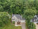 Beautiful home with lush surroundings, mature trees, and meticulously maintained landscaping creating a private and serene atmosphere at 7808 Sandy Bottom Way, Raleigh, NC 27613