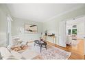 Inviting living room featuring hardwood floors, neutral walls, and a large window providing ample natural light at 7808 Sandy Bottom Way, Raleigh, NC 27613