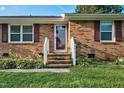 Welcoming front entrance of a brick home with a lovely landscaped garden at 801 Lincoln Dr, Rocky Mount, NC 27801