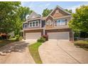 Street view of townhouses with well-maintained landscaping and private driveways at 809 Davidson Point Rd, Cary, NC 27513