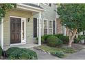 Welcoming front entrance with dark door, pristine landscaping, and prominent house number at 8326 Glenwood Springs Ct, Raleigh, NC 27616