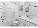 Bright bathroom featuring a shower-tub combo, a modern sink and vanity, and a neutral color palette at 915 Ball Field Aly # 104, Cary, NC 27511