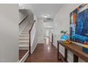Bright entryway with hardwood floors, staircase, and stylish console table at 948 Consortium Dr, Raleigh, NC 27603