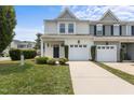 Inviting townhome features a one-car garage and well-maintained landscaping at 948 Consortium Dr, Raleigh, NC 27603
