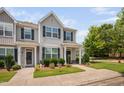 Two-story townhome with a well-maintained lawn and neutral color scheme at 102 Harvest Oaks Lane # 38, Durham, NC 27703