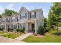 Beautiful two-story townhome with tidy landscaping and a welcoming entrance at 102 Harvest Oaks Lane # 38, Durham, NC 27703