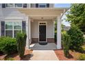 Inviting front porch with classic columns and well-maintained landscaping at 102 Harvest Oaks Lane # 38, Durham, NC 27703