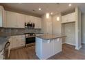 Modern kitchen boasts stainless steel appliances, granite countertops, and a functional kitchen island for meal preparation at 108 Freedom Heights Ln # 147, Smithfield, NC 27577