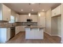 Well-equipped kitchen features white cabinets, stylish countertops, stainless steel appliances, and a convenient center island at 108 Freedom Heights Ln # 147, Smithfield, NC 27577