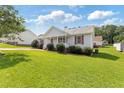 Well-maintained home featuring a green lawn and tidy landscaping in a quiet neighborhood at 1113 Curtiss Dr, Garner, NC 27529