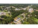 An aerial view showcases the community and surrounding areas, with trees and houses, and a water tower in the distance at 12658 W Hanes Ave, Middlesex, NC 27557