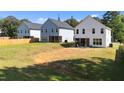 View of home's backyard, offering ample space for recreation and relaxation, with a view of other homes at 12658 W Hanes Ave, Middlesex, NC 27557