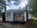 Side view of home features a front porch and updated black brick and trim at 1336 Hill Street St, Rocky Mount, NC 27801