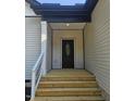 Close up of front porch featuring a decorative front door, steps, and railing at 1414 Sagamore Dr, Louisburg, NC 27549